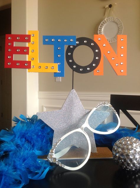 Elton table decor for symphony concert. Elton John Party Decorations, Elton John Birthday Party, Elton John Party Theme, Elton John Party, Band Decorations, Work Event Ideas, Karaoke Room, Parade Float, 12th Birthday