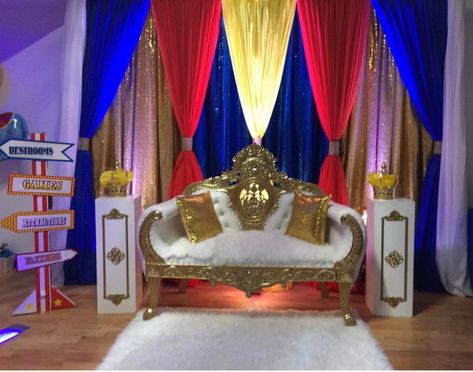 Blue, Red, Yellow, Gold Backdrop with gold and white loveseat Royal Blue Red And Gold Decor, Royal Blue Red And Gold Wedding, Royal Blue And Gold Backdrop Ideas, Quince Backdrop Ideas Red And Gold, Royal Blue Traditional Drape Wedding Sets, Royal Blue Main Table Quince, White Loveseat, Beauty And The Beast Theme, Gold Backdrop