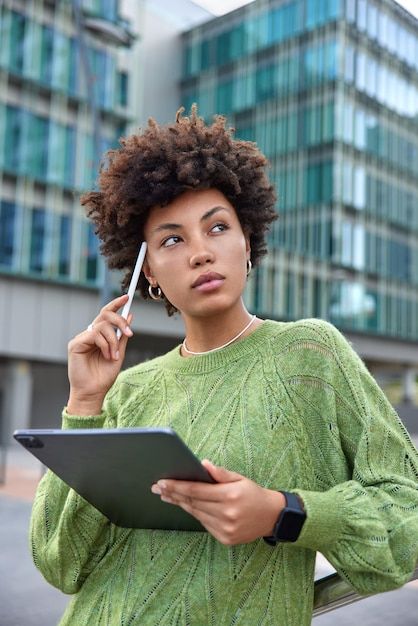 Free photo woman keeps stylus on temple ... | Free Photo #Freepik #freephoto #working-women #stylus #using-tablet #technology-woman Graphic Tablet, Green Jumper, Social Media Branding Design, Photo Woman, Green Jumpers, Graphic Design Assets, Studio Photography Poses, Marketing Photos, Study Photography