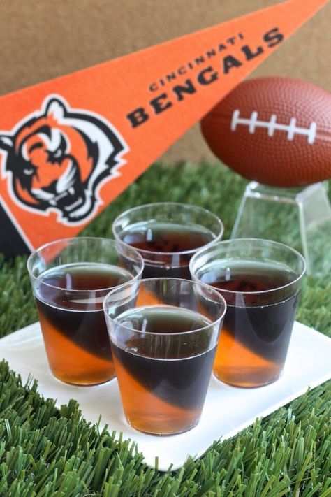 Cincinnati Bengals Jell-O Shots (3 oz. orange Jell-O 2 envelopes plain gelatin 2 cup vodka  3 1/2 Tbs grape Jell-O powder 3 1/2 Tbs lime Jell-O powder Black food coloring) Jell O Shots Recipe, Super Bowl Drinks, Jell O Shots, Jelly Shots, Black Food Coloring, Jello Shot, Bengals Football, Football Snacks, Football Party Food