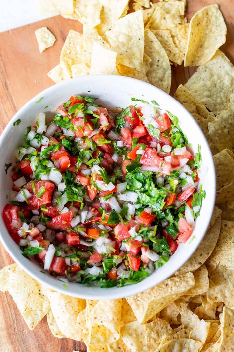 Super fast, easy and flavorful fresh salsa recipe for pico de gallo. Great as a dip or with any TexMex meal! Pico de gallo, also referred to as salsa fresca, is a fresh tomato salsa made with diced onion, tomato, jalapeño or serrano pepper, cilantro and lime juice. Pico is easy to make authentic and is a crowd-pleaser as a delicious fresh and flavorful dip with tortilla chips, in tacos or on top of tostadas and enchiladas. Pico De Galo Recipes, Fresh Salsa Recipe, Salsa Fresca, Fresh Tomato Salsa, Serrano Pepper, Fresh Salsa, Salsa Recipe, Crowd Pleaser, Fresh Tomatoes