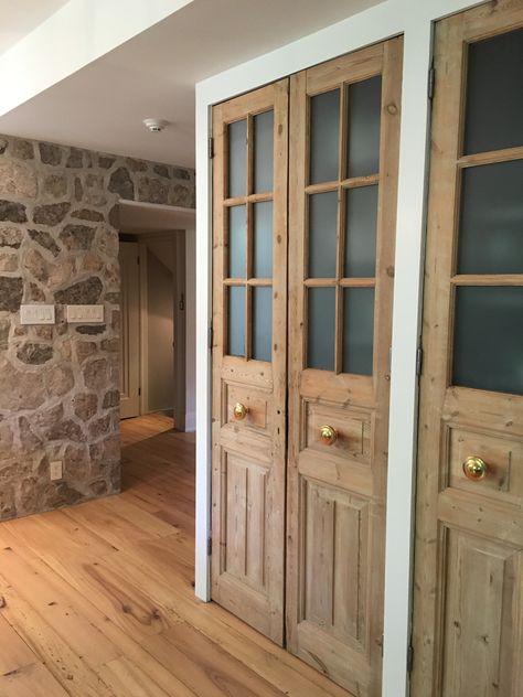 Old meets new. Tall pantry doors with frosted glass and brass pulls set against a stone wall and elm hardwood flooring. Pantry Door Ideas, Accent Wall In Kitchen, Open Pantry, Airing Cupboard, Stone Accent Walls, Built In Pantry, Old Home Remodel, Pantry Wall, Pantry Doors