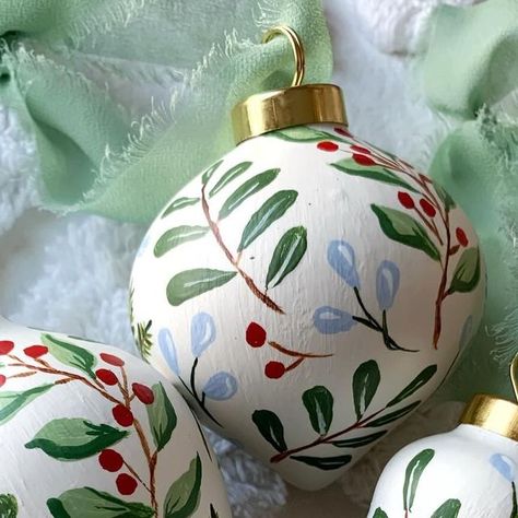 Mollie McGeever on Instagram: "I love that my customers are still ordering ornaments… that’s what I call planning ahead! This trio  from my “Greens & Berries” look so pretty together; each with a different shape. Available to order from my Etsy shop. #christmasornaments #handpaintedornaments #botanicalornaments #ceramicornamnets #handmadeornaments" Painting Ceramic Ornaments, Decorate Baubles, Painting Christmas Balls, Christmas Ceramics Ideas, Christmas Pottery Ideas Ceramics, Bauble Painting, Painted Ceramic Ornaments, Hand Painted Bauble, Wood Christmas Tree