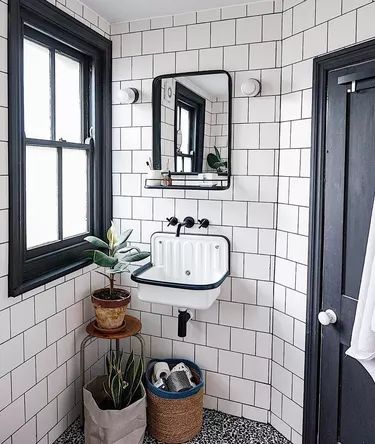 Small Industrial Bathroom, Industrial Bathroom Ideas, Bucket Sink, Black Floor Tiles, Sleek Bathroom, Industrial Bathroom, Unique Light Fixtures, Glass Shower Doors, Bathroom Style