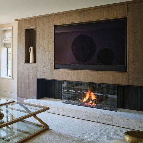 Hetherington Newman on Instagram: "Dark stained sandblasted oak adds texture & a contemporary rustic vibe to this sleek media wall. Build around the TV and fireplace, simple flat panels keep the lines clean & conceal some useful hidden storage. . . . . #interiordesign #interiordesigner #interiorarchitecture #mediawall #bespokejonery #sandblastedoak #minimaldesign #contemporaryrustic #homestyle #simpledesign #hiddenstorge #luxuryhome #belgianminimalism #contemporaryhome #contemporarystyle #minima Hide Tv Over Fireplace, Fireplace Simple, Tv And Fireplace, Tv Wall Panel, Storage Fireplace, Tv Over Fireplace, Oak Fireplace, Feature Wall Living Room, Fireplace Tv Wall