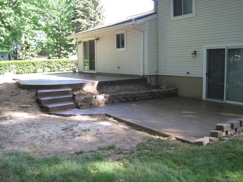 Multi-level patio with concrete steps. Raised Concrete Patio Ideas With Steps, Building A Deck Over Concrete Steps, Concrete Deck Ideas Raised, Composite Steps To Concrete Patio, Wide Concrete Steps To Patio, Low Maintenance Backyard, Concrete Backyard, Building A Floating Deck, Backyard Upgrades