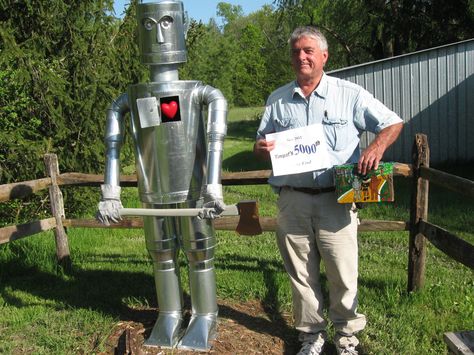 Each month, the global geocaching community meets three outstanding geocachers… Garden Scarecrow, Geo Caching, Tin Woodman, Geocache Containers, Geocaching Ideas, Tin Can Man, Tin Can Flowers, Recycled Garden Art, Tin Can Art