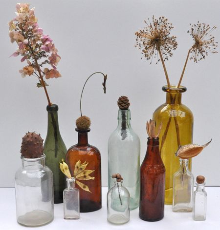 old bottles | Old bottles are great for display. Here I had fun using them with an ... Old Bottles Decor Projects, Displaying Bottles Ideas, Glass Bottle Display Ideas, Antique Bottles Decor Ideas, Dried Flowers In Bottles, Old Bottles Decor, Bottle Vases With Flowers, Candles In Bottles, Dried Flowers Display