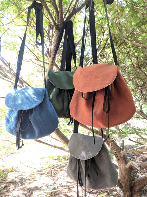 "Join the FOTW Realm and get an instant 10% off code! http://eepurl.com/hrobtv Medieval sporran style crossbody bag.  Allows hands free at the Renaissance Fair, lots of color options! Made with linen fabric, lined with heavy canvas for strength. Opens larger, closing with a drawstring cord that runs through antique brass grommets under the flap.   Roomy to carry a small wallet, smartphone, keys etc.  Long crossbody strap is 1\" wide black cotton twill, approx. 50\" long. (shorter or longer can b Steampunk Coloring, Fest Ideas, Steampunk Bag, Medieval Fair, Medieval Crafts, Ren Faire Costume, 2023 Ideas, Fair Outfits, Paper Dolls Clothing