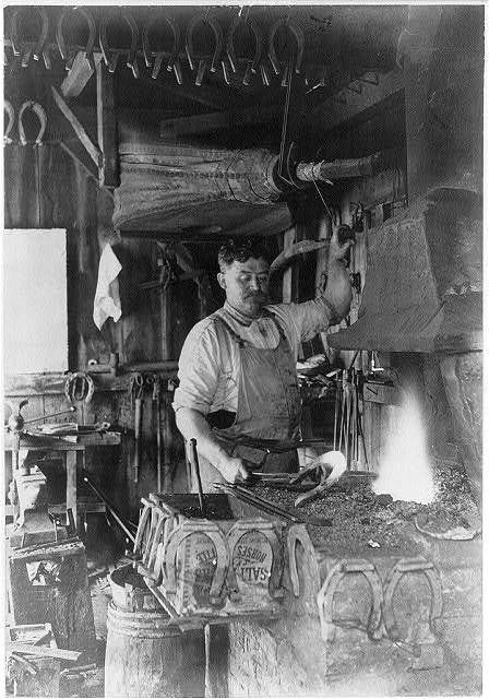 LABOR: Blacksmith making a horseshoe, 1909. | They are becoming less numbered in the cities, but still a necessity, nationwide. Many blacksmiths turned to auto repair. Blacksmith Workshop, Forging Hammer, The Blacksmith, University Of Montana, Blacksmith Forge, Memory Projects, Blacksmith Tools, Anvils, Blacksmith Shop