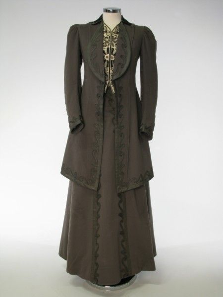 Coat and skirt, Horan Smith & Goulden Ltd., Manchester, England, 1908-1910. Grey wool. Coat lined with grey figured silk. Turn-down collar with rounded revers of black silk trimmed with black & silver braid. Narrow waistcoat fronts. White watered silk embroidered with black & silver braid, fastening with 9 hooks and eyes. 1900's Dress, 1910 Dress, 1900s Costume, Dress 1900, Silent Sky, Edwardian Dresses, Coat And Skirt, Manchester Art, Christine Daae