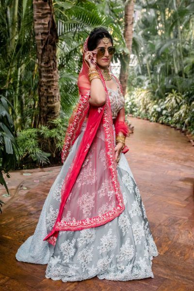 An Elegant Goa Wedding With Cherry Blossoms And The Bride In A Silver Grey & Red Lehenga | WedMeGood Silver Lehenga Color Combinations, Red Indian Suit, Silver Lengha, Unique Lehenga, Lehenga Color Combinations, Coordinated Outfits, Goa Wedding, Suite Design, Sunset Hues