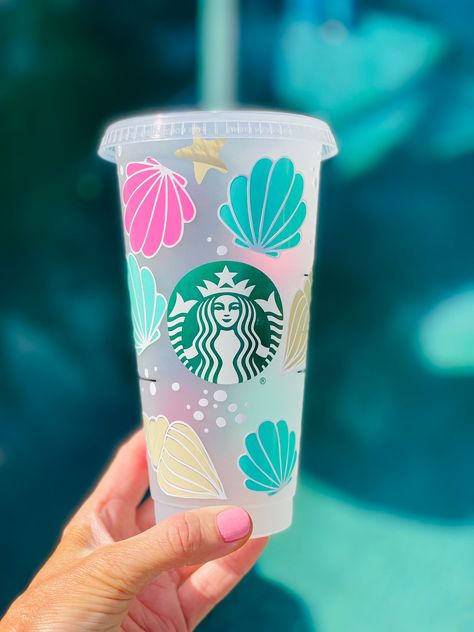 Enjoy your favorite beverages in style with our exquisite handcrafted seashell cup. This beautifully designed seashell cup is not just a functional drinkware item but also a piece of art that captures the natural beauty of the sea.  This imaginative Starbucks seashell-inspired cup is a must-have for Starbucks collectors and beach enthusiasts. Add a touch of coastal charm to your morning routine or make it a delightful gift for your fellow Starbucks lovers. Enjoy a sip of the sea with every brew! **Please message with any questions**  *Only ships to United States from Bakersfield, California Rush order please add the Rush Order Listing to Your cart before check out, Jump ahead in line Care Instruction Hand Wash Only Not Microwave or Dishwasher Safe Do not scrub or soak  Please follow us on Beach Cups, Beach Wedding Gifts, Preppy Decor, Bakersfield California, Starbucks Lovers, Beach Lover Gifts, Coastal Charm, Cute Cups, Starbucks Drinks