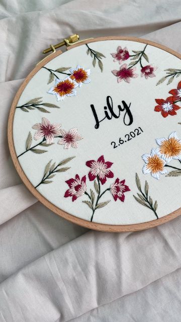 Nini • Embroidery Artist 🪡 on Instagram: "One of the best ways to embroider near the edge is to use a bigger hoop than the pattern 🪡 Pro tip: make sure the pattern is bigger than the original hoop size! Follow for more embroidery tips & tricks!" Embroidery Lily Flower, How To Finish Embroidery Hoop Back, Lily Embroidery Pattern, Lilly Embroidery, Lilies Embroidery, Embroidery Lily, Embroidered Lily, Beanie Embroidery, Embroidery Names