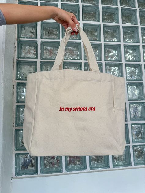 Because the Señora era is the best era! 100% cotton canvas / Red design Embroidered with love by JZD in Brownsville, TX Inside pocket  Measurements Tote bag: 14" x 14"  Depth: 5.5" Handles: 11" Senora Life, Quote Tote Bag, Bag Quotes, Embroidered Tote Bag, Boys Tops, Embroidered Tote, Cute Shirt Designs, Shirt Design Inspiration, Red Embroidery