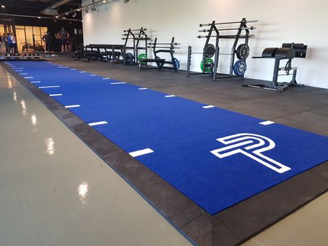 An Blue Heavy Sprinttrack Turf for Personal Training CLUB PT with white markings and logo. #sprinttrack #speedtrack #prowlersled #personaltraining #turf Sports Training Facility, Lab Ideas, School Designs, Cross Training Workouts, Gym Setup, Martial Arts School, Gym Interior, Blue Floor, Gym Ideas