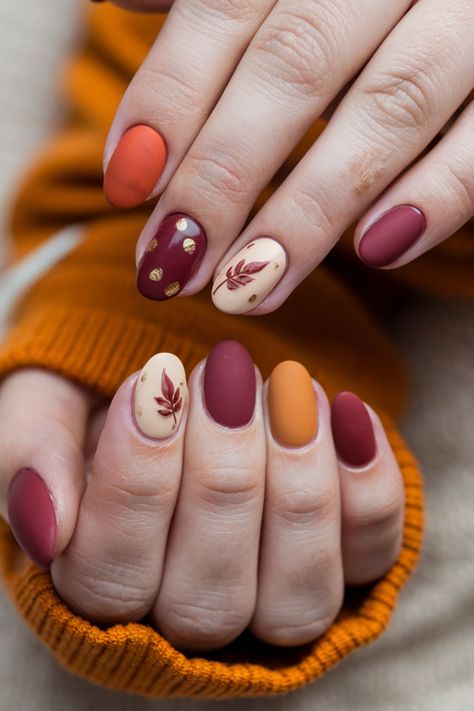 Dive into the season with these stunning round fall nail ideas that perfectly blend style and comfort. Featuring a rich berry base topped with golden leaf accents, this design captures the essence of autumn. The round shape adds a soft elegance, making your nails look effortlessly chic. Perfect for cozy gatherings or a casual day out, these fall nail ideas will leave everyone admiring your seasonal flair! Autumn Palette Nails, Thanksgiving Nails Ideas, Fall Color Palette Nails, Acorn Nails, Fall Round Nails, Franche Nails, Autumn Leaf Nails, Fall Leaves Nails, Nails Fall Autumn