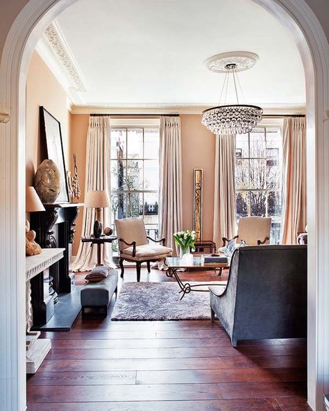 Simply elegant Victorian flat in Notting Hill Peach Living Room Walls, Grey Wood Floors Living Room, Peach Living Room, Arched Entry, Middle Table, Gray Couch, Living Room Wood Floor, Cream Curtains, Grey Wood Floors