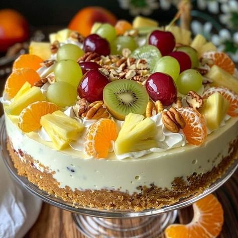 Recipes patisserie simple | Tropical Fruit Salad Cheesecake | Facebook Fruit Salad Cheesecake, Fruity Cheesecake, Desserts Faciles, Cheesecake Ingredients, Tropical Fruit Salad, Vanilla Wafer, Swirl Cheesecake, American Recipes, Salad Toppings