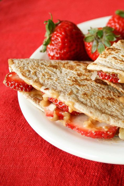 These easy Peanut Butter Tortilla Sandwiches give your same-old-same-old peanut butter and jelly sandwich a creative, deliciously fun makeover! Warm, gooey peanut butter is sandwiched in a crispy, toasty quesadilla. Choose fillings like fresh strawberries, crunchy almonds and sweet coconut to take it to a whole new level … with lots of ways to customize each one! Try Peanut Butter Tortillas, and your PB&J will never be quite the same again! | vegan | vegetarian | www.TwoHealthyKitchens.com 21 Day Fix Snacks, Beachbody 21 Day Fix, 21 Day Fix Diet, 21 Day Diet, 21 Day Fix Meal Plan, Beachbody Recipes, 21 Day Fix Meals, Healthy Kitchen, Idee Pasto Sano