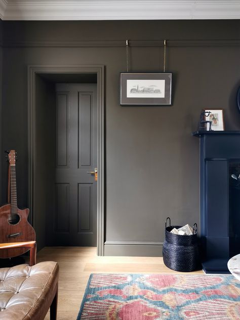 A muddy-toned (brown / green), cosy living room with oak flooring, Italian marble coffee table, vintage mid-century leather chair, cast iron fire place and picture rail. Farrow And Ball Living Rooms, London Clay Farrow And Ball, London Clay, Mid Century Leather Chair, House Mid Century, Farrow And Ball Living Room, Living Room Transitional, Colorful Eclectic, Bedroom Victorian