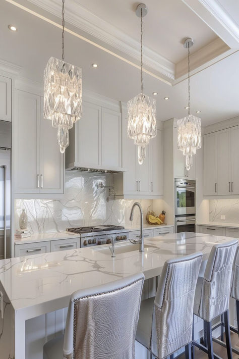 A serene kitchen featuring three geometric pendant lights above a white marble island, complete with soft beige-toned seating. Pendent Lighting Over Island, Kitchen Lights Over Island, Serene Kitchen, Pendant Lighting Over Island, Pendant Lighting Ideas, Lights Over Island, Glam Kitchen, Bar Pendant Lights, Chrome Pendant Lighting