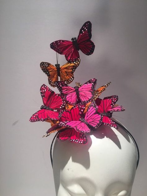 Butterfly Fascinator- Red, Hot pink- Orange Headband- Easter Headpiece- Wedding- Kentucky Derby- Mad Hatter- Tea Party   Hi, This butterfly headband/fascinator is made with feather butterflies that perch on black 3 inch sinamay circle. 5 inches wide by 7 inches high.  Note: Its finished in the back Butterfly Fascinator, Easter Tea Party, Fascinator Hats Diy, Butterfly Headband, Party Face Masks, Hat Tea Party, Headband Fascinator, Fascinator Wedding, Derby Fascinator