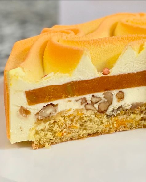 This entremet cake is all about layers of flavour and texture, wrapped in a design that’s just as impressive as its taste. The base is a moist carrot and orange sponge, paired perfectly with a tangy orange confit. For added texture, there's a crunchy layer that gives the cake a satisfying bite. The entire cake is enveloped in a velvety smooth mousse, creating a luxurious contrast to the crunch. To top it all off, I used a tessellation mould from @dinarakasko @dinarakaskomoulds to give the c... Orange Entremet, Entremet Cake, Pumpkin Spice, Carrots, Baking, Texture, Orange, Cake, Quick Saves