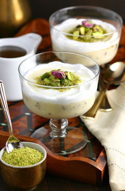 A very popular dessert throughout the Middle East, this Lebanese Semolina Pudding (Layali Lubnan) includes sweet-tart cranberries, thick coconut cream, ground pistachios, and a floral-scented syrup. This vegan recipe can be whipped up quickly, then it chills in the fridge until you are ready to dig in. Layali Lubnan, Arabisk Mat, Arabisk Mad, Semolina Pudding, Lebanese Desserts, Arabic Desserts, حلويات عربية, Popular Dessert, Arabic Dessert