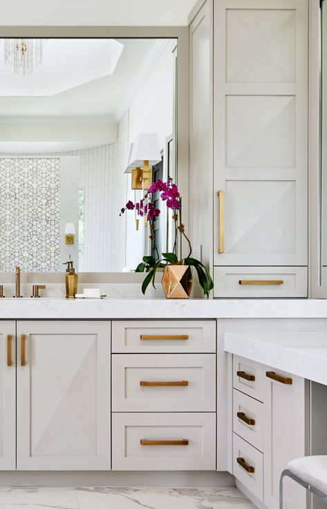 Soft taupe custom cabinets with antique gold hardware grace this luxurious master bath by Haven Design & Construction. The raised cabinet design on the doors echoes the marble and mosaic tile across the bathroom. This bathroom also features a freestanding tub, a shell chandelier in the 22' high cupola, a striking gold and marble mosaic accent wall behind the tub and a curved walk in shower. Luxurious Master Bath, Fossil Creek, Best Kitchen Design, Wall Cabinets, Master Bath Remodel, Casa Exterior, Home Luxury, Gold Bathroom, Diy Bathroom Decor