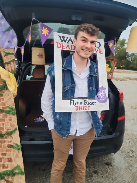 Tangled's Flynn Rider halloween costume for a trunk or treat event. Hamilton Trunk Or Treat, Trunk Or Treat Tangled, Trunk Or Treat Ideas With Costumes, Trunk Or Treat Rapunzel, Rapunzel Trunk Or Treat Ideas, Tangled Trunk Or Treat Ideas, Disneyland Trunk Or Treat, Cars Halloween Costume Family, Rapunzel Trunk Or Treat