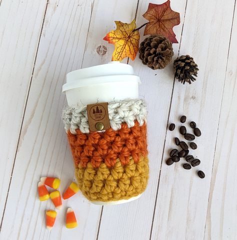 "Add some Fall fun and coziness to your coffee or tea To-Go cup with this adorable Candy Corn style crocheted coffee sleeve. This fun cup cozy is sure to brighten your day! This reusable sleeve is easy to carry with you to slip onto your coffee To-Go cup in place of the cardboard sleeve.  Use this cozy to protect your fingers from hot beverages while adding fun to your day! Made with soft, chunky acrylic/wool blend yarn, the Cup Cozy is hand washable in cool and line dry. //SIZE One size will fi November Crochet Ideas, Pumpkin Cup Cozy, Crochet Coffee Sleeve, Candy Corn Pumpkin, Fall Crochet Projects, Cup Cozy Pattern, Crochet Mug Cozy, Pumpkin Cups, Crochet Coffee Cozy