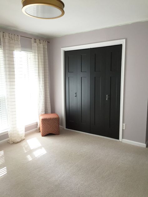 If you have to have bifold closet doors, this is the way to go. Black Closet Bifold Doors, Black Bedroom Closet Doors, Painted Bedroom Closet Doors, Trifold Closet Doors Makeover, Dark Closet Doors, Painted Sliding Closet Doors, Bifold Closet Door Makeover Diy Ideas, Black Closet Doors Bedrooms, Black Bifold Closet Doors