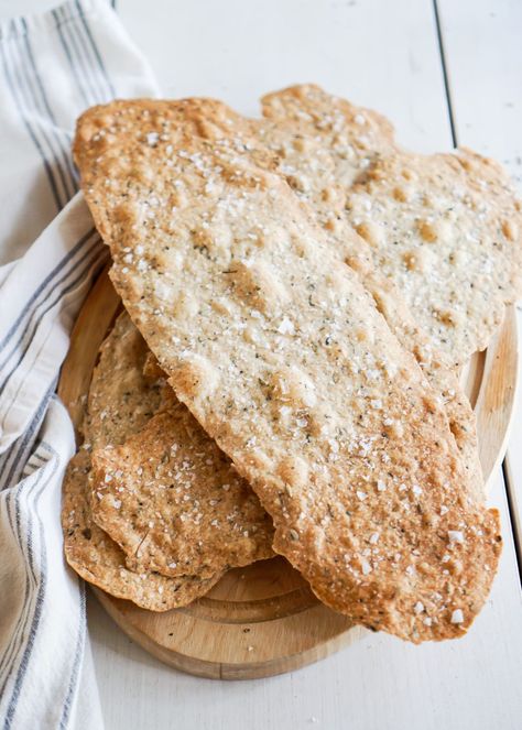 Homemade crackers are fun and simple to make. They are a flat, crisp cracker loaded with Herbs de Provence and sprinkled with flaked Maldon sea salt. These crackers make a great addition to a cheese board or as a hostess gift. Change up the herbs for your favourite flavours. Mediterranean Crackers, Crackers Homemade, Ouster Crackers Seasoned Dill, Homemade Rosemary Crackers, Ouster Crackers Dill, Parmesan Herb Crackers, Parmesan Herb Sourdough Crackers, Homemade Crackers Recipe, Savoury Crackers