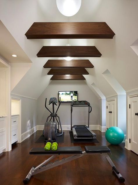 Attic home gym boasts a vaulted cieling adorned with wood beams placed over gym equipment facing a flat panel tv. Attic Library, Attic Renovation Ideas, Finished Attic, Media Room Design, Attic Playroom, Attic Loft, Exercise Room, Reformer Pilates, Small Attic