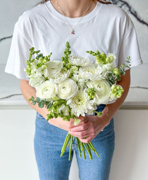 A crisp white breeze of cloud-like chrysanthemums, petal-packed ranunculus and white-hot snapdragons! Important deets: Some ranunculus will arrive budded as they are fresh from the grower but will open beautifully and can be enjoyed for longer! The exact varieties and colour may vary slightly (because, nature!) but your blooms will be beautiful and fresh - guaranteed! Bridal Bouquet With Snapdragons, White Ranunculus Arrangement, Snapdragon Flowers Wedding, White Rose And Ranunculus Bouquet, Ranunculus And Rose Bouquet, Snapdragon Wedding Bouquet, Ranunculus Bouquet White, Ranunculus Bouquet Wedding, Foxglove Wedding