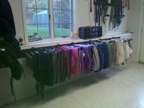 USE: Create more shelf space/allows pads to dry. Also looks neat and impressive!  NEED: Shelf bracket, thick dowel/rod, screws Saddle Pad Rack, Saddle Pad Storage, Pad Organization, Tack Room Ideas, Tack Storage, Tack Room Organization, Feed Room, Horse Tack Rooms, Barn Remodel