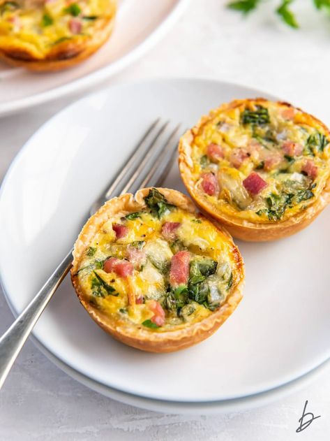 two muffin tin quiches on a white plate with a fork. Muffin Tin Quiche, Mini Quiche Recipes, Quiche Muffins, Breakfast Quiche Recipes, Mini Quiches, Breakfast Quiche, Mini Quiche, Quiche Recipe, Homemade Pie Crusts