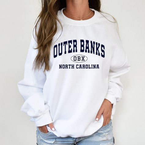 💖Outer Banks Sweatshirt, North Carolina Sweater, Pogue Life Gift, OBX Sweater,  Outer Banks Gift Hoodie, Carolina Sweat Gift Unisex Crew Neck Sweatshirt | Gildan 18000 This well-loved Unisex Crew Neck Sweatshirt is the perfect addition to any collection! The air-jet spun yarn and quarter-turned fabric helps eliminate creases and piling,  while the mix of cotton and polyester creates a soft and comfortable feel. 50% cotton, 50% polyester. Unisex Heavy Blend Hoodie | Gildan 18500 With a large fro Outer Banks Sweatshirt, Outfit Outer, Pogue Life, Fall Shirts Women, Black Sweats, Coffee Sweatshirt, Cute Shirt Designs, Casual Preppy Outfits, Branded Sweatshirts