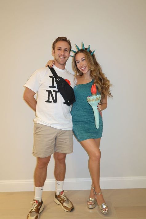 Looking for unique couples Halloween costumes for 2024? Recreate this Statue of Liberty and tourist couples costume! I dressed as Lady Liberty with an emerald green dress and headband. My fiancé had a camera, fanny pack, and tourist t-shirt to complete our NYC-themed idea. Check out my Instagram post showing our costumes in more detail. Diy Statue Of Liberty Costume, Lady Liberty Costume, Tourist Costume, Tourist Outfit, Unique Couple Halloween Costumes, Couples Halloween Costumes, Green Costumes, Emerald Green Dress, Couples Costume