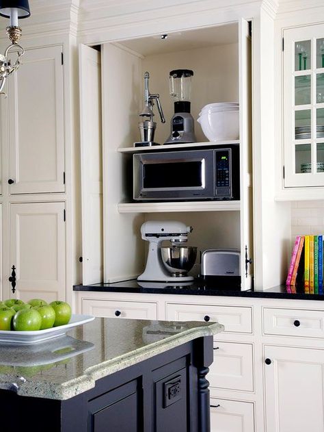 Store your mixer, blender, food processor and other small appliances in a place that off your counter and combat clutter. Get our ideas for custom cabinets, free standing shelves and other storage ideas for these small kitchen appliances. Appliance Closet, Retractable Doors, Hide Appliances, Farmhouse Kitchen Cabinets, Kitchen Cabinets Makeover, Kitchen Redo, Kitchen Remodel Idea, Kitchen Makeover, White Cabinets