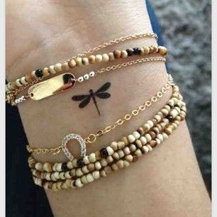 This one maybe in white ink.    A small dragonfly: | 65 Totally Inspiring Ideas For Wrist Tattoos Tattoo Dragonfly, Small Dragonfly Tattoo, Sanskrit Tattoo, Dragonfly Tattoo Design, Tato Henna, Dragonfly Tattoo, Mother Daughter Tattoos, Subtle Tattoos, Small Tattoo Designs