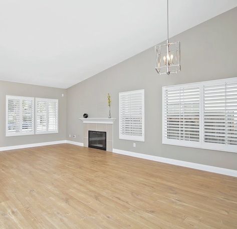 🏡🛠 Perfect neutral gray walls, light oak floors, and that gorgeous industrial cage pendant light 😍 • • • 💻www.BuyInvestSell.com… Oak Floor Grey Walls, Light Wood Floors With Gray Walls, Flooring With Light Gray Walls, Gray Walls Light Wood Floors, Oak Floors White Walls, Wood Floors Gray Walls, Living Room With Oak Floors, Floors With Grey Walls, Light Oak Wood Floors