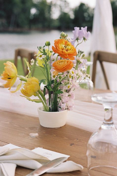 Colorful garden wedding inspo yellow orange purple Charleston wedding florist Florida bride Small Garden Wedding Reception Table Arrangements chamomille stock sweet pea tulips butterfly ranunculus frog vessel Small Garden Wedding Reception, Flower Frog Wedding, Reception Table Arrangements, Flower Frog Arrangement Wedding, Colorful Bar Arrangement Wedding, Frog Arrangement, Purple And Yellow Flower Arrangements Wedding, Flower Frog Arrangement, Small Garden Wedding