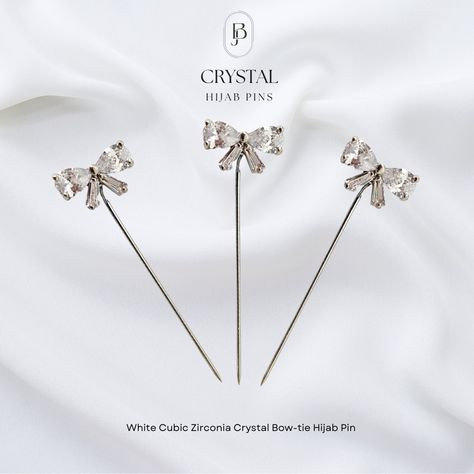 White Cubic Zirconia Crystal Bow-tie Hijab Pin Code: CR037 Color: White Dimensions:18mmX55mm Weight:12g Price: MVR 60.00 e-tukuri link: https://shop.etukuri.mv/products/white-cubic-zirconia-crystal-bow-tie-hijab-pin Hijab Bow Pin, Tie Hijab, Formal White Bow Brooch, Elegant White Crystal Brooch, Silver Cubic Zirconia Jewelry With Bow Detail, Elegant Silver Brooch With Bow, Pin Code, Hijab Pins, Bow Tie