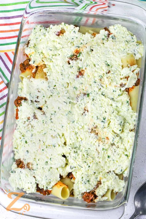 Baked rigatoni is a cheesy and easy to make meal in one. Simple ingredients are what make this baked rigatoni a success! This calls for three kinds of cheese - ricotta, parmesan, and mozzarella. These are mixed together with some egg and then layered between ground beef and rigatoni noodles. #bakedrigatoni #bakedrigatonirecipe #rigatoni #ourzestylife Ricotta Beef Pasta, Baked Rigatoni With Ricotta Cheese, Baked Sausage Rigatoni, Rigatoni Recipes With Ricotta Cheese, Ground Beef And Ricotta Cheese Recipes, Ricotta Cheese Recipes Pasta, Baked Rigatoni With Ricotta, Rigatoni Casserole, Baked Rigatoni Recipe