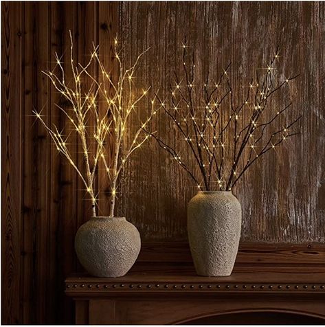 Cultivate a winter forest with lit branches that lend a magical glow to indoor and outdoor settings. Dotted with warm-white fairy lights, the branches look elegant on their own or trimmed with ornaments  #christmasdecor #lights #holidaydecor #whitelights #manteldecor #tabletopdecor #affiliate #amazonassociate Artificial Tree Branches, Vase With Branches, Warm White Fairy Lights, Twig Lights, White Fairy Lights, White Branches, Fall Vignettes, Warm White Lights, Twig Branch