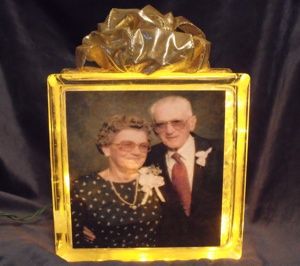 I recently made a Memorial Block for the family of a lady in my Sunday School class who had passed away. I got sick of paying too much money for a few flowers that died in a few days. Christmas Glass Blocks, Glass Block Crafts, Lighted Glass Blocks, White Fairy Lights, Block Craft, Glass Block, Photo Decor, Perfect Wedding Gift, Glass Boxes