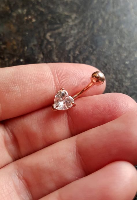 This classic and beautiful navel ring holds onto a Heart shaped CZ crystal. (1) Navel ring per order Gem Size: Approx. 7-10mm 3/8 Curved Cute Belly Rings, Belly Button Piercings, Belly Piercings, Bellybutton Piercings, Belly Button Piercing Jewelry, Belly Piercing Ring, Belly Piercing Jewelry, Ring Piercing, Belly Button Jewelry