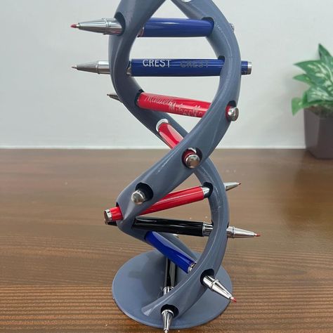 Elevate your workspace with our 3D Printed DNA Pen Holder! Inspired by the iconic double helix structure, this pen holder is a must-have for science enthusiasts, students, and professionals alike. Not only does it keep your writing tools organized, but it also adds a sophisticated, scientific touch to your desk. Key Features: Scientific Design: Features a detailed DNA double helix, making it a perfect desk accessory for those who love science and biology. Functional & Decorative: Holds pens, pencils, and other small items while serving as an eye-catching piece of decor. High-Quality PLA Material: Made from durable, eco-friendly PLA plastic, ensuring a long-lasting and sustainable product. Perfect Gift: Ideal for scientists, teachers, students, or anyone passionate about the wonders of biol Useful 3d Prints Products, Practical 3d Printing Ideas, Biology Decorations, 3d Printed Gifts, Scientific Design, Ed Design, Office Themes, Desk Gifts, Science Lover